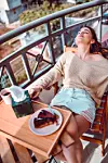 Female Relaxing With Cake And Coffee During Weekends
