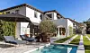 Los Angeles, CA - Troubled couple Lori Loughlin and Mossimo Giannulli sell Bel-Air mansion amid college admissions scandal. As their looming sentencing date fast approaches, the couple are cutting ties to their current neighborhood in LA’s posh Bel Air area. In addition to resigning from the exclusive Bel-Air Country Club, the couple’s nearby mansion is also in escrow to be sold, sources say. The buyer is Tinder co-founder Justin Mateen, a Los Angeles native who already owns a substantial luxury real estate portfolio. The heavily discounted deal has not yet recorded but the sources say the sale price 'significantly' undercuts the property’s most recent .7 million price tag. According to one source, the agreed-upon amount is million. Walled and gated for privacy, the 12,000 sq ft villa’s architecture is perhaps best described as Mediterranean with a heady contemporary twist. Behind a towering hedgerow lies a generously-scaled motor court which leads to a long flight of olive tree-lined steps to the mansion’s front door. Inside, there's a foyer with a double-height ceiling, a vividly basket-weave patterned stone floor and a long wall of glass doors that individually pivot out to a slim loggia, where there’s lush views of the adjacent country club. A baronial living room opens on one side to the backyard lawn; on the other, to a courtyard with a lap-lane swimming pool. Other spaces include a lounge, formal dining room, gourmet kitchen with marble countertops and restaurant-quality appliances, and five guest bedrooms, plus an upstairs master suite with dual baths and closets. Longtime fans of beauty YouTuber Olivia Jade - Loughlin and Giannulli’s younger daughter - will undoubtedly recognize many of this home’s interior spaces, which were frequently featured on her YouTube channel. The house has also hosted a number of other prominent YouTube creators, including David Dobrik, Zane Hijazi and Trisha Paytas, who all filmed at the property prior to the college admissions scandal being publicized. It’s not yet known where Loughlin and Giannulli plan to live after their sentences are completed, but Loughlin is expected to receive two months in prison and be ordered to pay a 0,000 fine. Giannulli will receive five months and pay 0,000 for his part in paying 0,000 to have the couple’s two daughters admitted to USC. The couple’s sentencing is scheduled for August 21, 2020. *BACKGRID DOES NOT CLAIM ANY COPYRIGHT OR LICENSE IN THE ATTACHED MATERIAL. ANY BACKGRID UK 11 JULY 2020,Image: 542144790, License: Rights-managed, Restrictions: RIGHTS: WORLDWIDE EXCEPT IN UNITED STATES, Model Release: no, Credit line: Realtor.com / BACKGRID / Backgrid UK / Profimedia