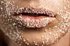 macro shot of unrecognizable woman skin and lips with sugar on it, beauty treatment concept.