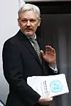 LONDON, ENGLAND - FEBRUARY 05: Wikileaks founder Julian Assange waves as he returns inside after speaking from the balcony of the Ecuadorian embassy where he continues to seek asylum following an extradition request from Sweden in 2012, on February 5, 2016 in London, England. The United Nations Working Group on Arbitrary Detention has insisted that Mr Assange's detention should be brought to an end. (Photo by Carl Court/Getty Images)