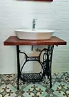 Lavabo na postolju od šivaćeg stroja.