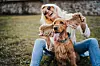 Young woman playing dog in park