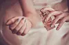 bride applying perfume on her wrist