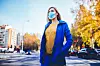 Young woman wearing face mask because of air pollution in the city
