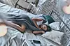 Peaceful sleep. Top view of attractive young woman covered with blanket keeping eyes closed and smiling while lying on the bed at home