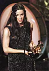 Canadian singer Alanis Morrisette receives her award for the Best Rock Vocal Performance at the 41st Grammy Awards at the Shrine Auditorium in Los Angeles 24 February. (DIGITAL IMAGE) AFP PHOTO/Hector MATA (Photo by HECTOR MATA / AFP)