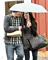 #8275221 Songstress Alanis Morissette cuddled up to her husband Mario “MC Souleye” Treadway under an umbrella in an attempt to stay dry after lunch at the Brentwood Country Mart in Los Angeles, California on December 12, 2011., Image: 109126079, License: Rights-managed, Restrictions: , Model Release: no, Credit line: Fame Pictures / Backgrid USA / Profimedia