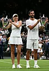 Croatia‘s Mate Pavic (R) and Ukraine‘s Lyudmyla Kichenok pose with their trophies after beating Belgium‘s Joran Vliegen and China‘s Yifan Xu during their mixed doubles final tennis match on the eleventh day of the 2023 Wimbledon Championships at The All England Lawn Tennis Club in Wimbledon, southwest London, on July 13, 2023. (Photo by SEBASTIEN BOZON/AFP)/RESTRICTED TO EDITORIAL USE