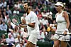 Croatia‘s Mate Pavic (L) and Ukraine‘s Lyudmyla Kichenok (L) celebrate beating Belgium‘s Joran Vliegen and China‘s Yifan Xu during their mixed doubles final tennis match on the eleventh day of the 2023 Wimbledon Championships at The All England Lawn Tennis Club in Wimbledon, southwest London, on July 13, 2023. (Photo by SEBASTIEN BOZON/AFP)/RESTRICTED TO EDITORIAL USE
