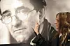 US singer Patti Smith poses in front of a giant poster of late Chilean writer Roberto Bolano in Madrid on November 26, 2010 during a ceremony at the Casa de America, announcing a week paying tribute to Bolano. AFP PHOTO/ DOMINIQUE FAGET (Photo by DOMINIQUE FAGET/AFP)