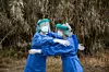 HUESCA, SPAIN - APRIL 27: Miriam and Isabel, two government nurses hug after conducting coronavirus tests on care workers who will replace the confined staff members, in the gardens of the nursing home on April 27, 2020 in Grañen, Huesca, Spain. The care workers at the Los Monegros nursing home in Grañén left after being confined in the center for nearly a month. Since March 30 they decided to remain with their residents to avoid the spread of Covid-19 infection. (Photo by Alvaro Calvo/Getty Images)