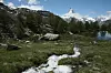 ZERMATT, SWITZERLAND - JUNE 30: A small stream leads to a lake near Sunnegga station as the Matterhorn stands behind on June 30, 2013 near Zermatt, Switzerland. Zermatt is among Switzerland's most famous winter and summer tourism destinations. (Photo by Sean Gallup/Getty Images)
