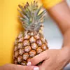 Pineapple. Woman holding a fresh pineapple (Ananas sp.). Pineapples are a good source of dietary fibre and vitamin C.,Image: 102261099, License: Rights-managed, Restrictions: , Model Release: no, Credit line: Science Photo Library / Sciencephoto / Profimedia