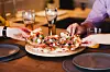 Friends eating pizza at the table