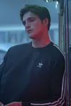 Jacob Elordi kao Nate Jacobs, srednjoškolski atletičar čiji problemi s bijesom provociraju njegove seksualne nesigurnosti