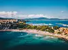 A picturesque aerial shot of Sozopol, Bulgaria, showcasing the charming old town with its historic architecture, sandy beach, and crystal-clear waters of the Black Sea.