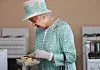 PERTH, AUSTRALIA - OCTOBER 27: Queen Elizabeth II receives scones from the Clontarf kitchen during her visit to Clontarf Aboriginal college on October 27, 2011 in Perth, Australia. The Queen and Duke of Edinburgh are on a 10-day visit to Australia and will travel to Canberra, Brisbane, and Melbourne before heading to Perth for the Commonwealth Heads of Government meeting. This is the Queen's 16th official visit to Australia. (Photo by Sharon Smith-Pool/Getty Images)