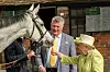 DITCHEAT, UNITED KINGDOM - MARCH 28: Queen Elizabeth II feeds a carrot to horse Politologue as trainer Paul Nicholls (C) looks on during a visit to Manor Farm Stables on March 28, 2019 in Ditcheat, United Kingdom. (Photo by Matt Keeble - WPA Pool/Getty Images)