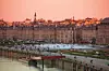 Miroir d'Eau water mirror fountain at Place de la Bourse and city buildings at sunset, Bordeaux, Gironde, Aquitane, France.
