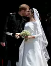 WINDSOR, UNITED KINGDOM - MAY 19: Prince Harry, Duke of Sussex and The Duchess of Sussex share a kiss after their wedding at St George's Chapel at Windsor Castle on May 19, 2018 in Windsor, England. (Photo by Jane Barlow - WPA Pool/Getty Images)