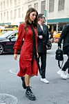 NEW YORK, NY - SEPTEMBER: A guest wearing a red dress and platform combat boots is seen outside Coach 1941 during New York Fashion Week on September 10, 2019 in New York City. (Photo by David Dee Delgado/Getty Images)