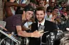 HOLLYWOOD, CA - JUNE 20: Actor Liam Hemsworth (R) takes a selfie with a fan during the premiere of 20th Century Fox's