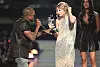 NEW YORK - SEPTEMBER 13: Kanye West (L) jumps onstage after Taylor Swift (C) won the
