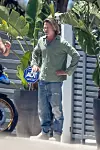 Malibu, CA - *EXCLUSIVE* - *Web Must Call For Pricing* Rocker Flea gets animated with friend Brad Pitt in Malibu as he shows him his BMW R1250 motorcycle. The actor stepped out sporting longer hair that was reminiscent of his glorious tresses in