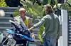 Malibu, CA - *EXCLUSIVE* - *Web Must Call For Pricing* Rocker Flea gets animated with friend Brad Pitt in Malibu as he shows him his BMW R1250 motorcycle. The actor stepped out sporting longer hair that was reminiscent of his glorious tresses in