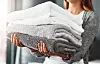 Cropped shot of an unrecognizable young woman doing her laundry at home