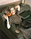 Jane Fonda, US actress, wearing a green and brown large check dress, posing with a cigarette and reclining on a green sofa, resting her head on a pink cushion, in a studio portrait, circa 1960. (Photo by Silver Screen Collection/Getty Images)