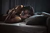 Sexy couple in love kissing during romantic moment in a bed.