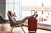 Young beautiful businesswoman with luggage in Airport waiting room.