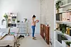 Young woman during reconstruction of apartment, holding color chart and choosing the right color for the wall