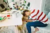 Photo of young woman having a company while working from home office