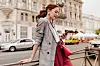 Red haired woman in stylish outfit chatting on phone