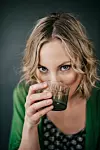 Young woman drinking green juice