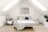 Interior of a Scandinavian style attic bedroom.