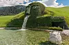 Wattens, Austria - August 18, 2011: The Giant, waterspout and fountain at the entrance of Swarovski Kristallwelten in Wattens, Austria.