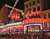 PARIS, FRANCE - DECEMBER 30: Moulin Rouge on December 30, 2019 in Paris, France. Moulin Rouge is a cabaret in Paris. The original house, which burned down in 1915, was co-founded in 1889 by Charles Zidler and Joseph Oller. Moulin Rouge is best known as the birthplace of the modern form of the can-can dance. Moulin Rouge is a tourist attraction, offering musical dance entertainment. (Photo by Athanasios Gioumpasis/Getty Images)