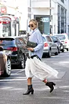 LONDON, ENGLAND - SEPTEMBER 15: Nina Suess wears a Zara shirt, Givenchy sunglasses, Chloe skirt, Kurt Geiger boots and bag on September 15, 2019 in London, England. (Photo by Kirstin Sinclair/Getty Images for Kurt Geiger)