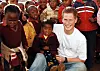 Prince Harry wears a shirt with the Sentebale logo as he holds a small girl while on visit to the Good Shepherd home, on a return visit to Lesotho. The Prince was in the country to launch his new charity called 'Sentebale', which means 'Forget me not', to benefit children orphaned by AIDS PRINCE HARRY IN LESOTHO TO LAUNCH A NEW CHARITY CALLED 'SENTEBALE', LESOTHO - 24 APR 2006, Image: 223734840, License: Rights-managed, Restrictions: NOT UK UNTIL 26 MAY 2006, Model Release: no, Credit line: REX / Shutterstock Editorial / Profimedia