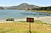PIRU, CALIFORNIA - JULY 09: An emergency response vehicle sits in a parking lot near a danger sign warning visitor of hazards for swimming and wading at Lake Piru, where actress Naya Rivera was reported missing Wednesday, on July 9, 2020 in Piru, California. Rivera, known for her role in