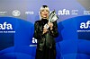 Plavokosa žena u crnoj kožnoj odjeći pozira pred logotipima Adriatic Film Awards.