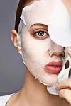 woman wearing an korean facial sheet mask