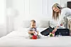 Travelling with kids. Happy mother with her child packing clothes for their holiday