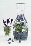 Infused water with blueberries and lavender in a pitcher