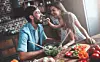 Mom, dad and daughter are cooking on kitchen. Happy family concept. Handsome man, attractive young woman and their cute little daughter are making salad together. Healthy lifestyle.